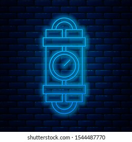Glowing neon line Detonate dynamite bomb stick and timer clock icon isolated on brick wall background. Time bomb - explosion danger concept.  Vector Illustration