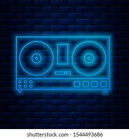 Glowing neon line DJ remote for playing and mixing music icon isolated on brick wall background. DJ mixer complete with vinyl player and remote control.  Vector Illustration