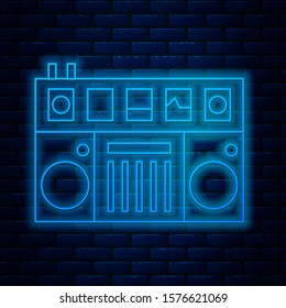 Glowing neon line DJ remote for playing and mixing music icon isolated on brick wall background. DJ mixer complete with vinyl player and remote control.  Vector Illustration