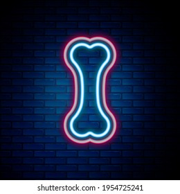 Glowing neon line Dog bone icon isolated on brick wall background. Pets food symbol. Colorful outline concept. Vector