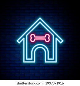 Glowing neon line Dog house and bone icon isolated on brick wall background. Dog kennel. Colorful outline concept. Vector