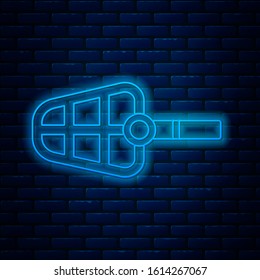 Glowing neon line Dog muzzle icon isolated on brick wall background.  Vector Illustration