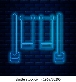 Glowing neon line Double swing for kids summer games on playground icon isolated on brick wall background. Outdoor entertainment equipment.  Vector