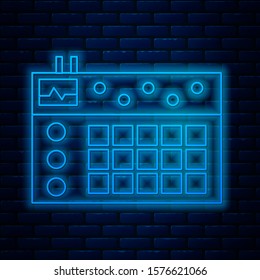 Glowing neon line Drum machine icon isolated on brick wall background. Musical equipment.  Vector Illustration