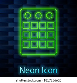 Glowing neon line Drum machine icon isolated on brick wall background. Musical equipment. Vector.