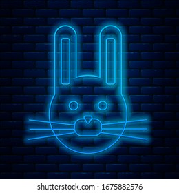 Glowing neon line Easter rabbit icon isolated on brick wall background. Easter Bunny.  Vector Illustration