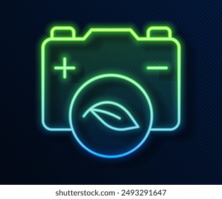 Glowing neon line Eco nature leaf and battery icon isolated on blue background. Energy based on ecology saving concept.  Vector