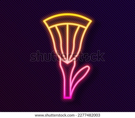 Glowing neon line Egyptian lotus icon isolated on black background.  Vector