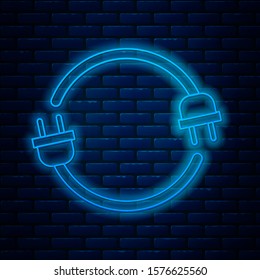Glowing neon line Electric plug icon isolated on brick wall background. Concept of connection and disconnection of the electricity.  Vector Illustration