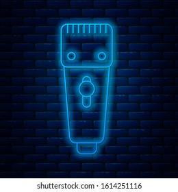 Glowing neon line Electrical hair clipper or shaver icon isolated on brick wall background. Barbershop symbol.  Vector Illustration