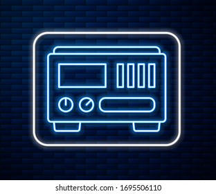 Glowing neon line Electrical measuring instruments icon isolated on brick wall background. Analog devices. Electrical appliances.  Vector Illustration