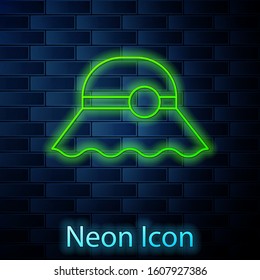 Glowing neon line Elegant women hat icon isolated on brick wall background.  Vector Illustration