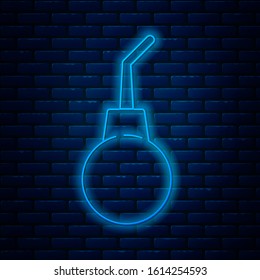 Glowing neon line Enema pear icon isolated on brick wall background. Medical rubber pump.  Vector Illustration