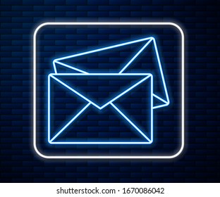 Glowing neon line Envelope icon isolated on brick wall background. Email message letter symbol.  Vector Illustration