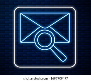 Glowing neon line Envelope mail with magnifying glass icon isolated on brick wall background.  Vector Illustration