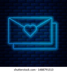 Glowing neon line Envelope with Valentine heart icon isolated on brick wall background. Message love. Letter love and romance.  Vector Illustration