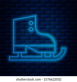 Glowing neon line Figure skates icon isolated on brick wall background. Ice skate shoes icon. Sport boots with blades.  Vector Illustration