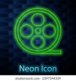 Glowing neon line Film reel icon isolated on brick wall background.  Vector