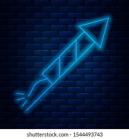 Glowing neon line Firework rocket icon isolated on brick wall background. Concept of fun party. Explosive pyrotechnic symbol.  Vector Illustration
