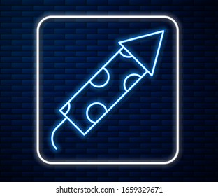 Glowing neon line Firework rocket icon isolated on brick wall background. Concept of fun party. Explosive pyrotechnic symbol.  Vector Illustration
