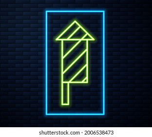 Glowing neon line Firework rocket icon isolated on brick wall background. Concept of fun party. Explosive pyrotechnic symbol.  Vector