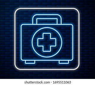 Glowing neon line First aid kit icon isolated on brick wall background. Medical box with cross. Medical equipment for emergency. Healthcare concept.  Vector Illustration