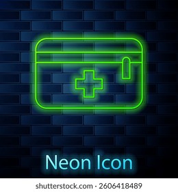 Glowing neon line First aid kit icon isolated on brick wall background. Medical box with cross. Medical equipment for emergency. Healthcare concept.  Vector Illustration