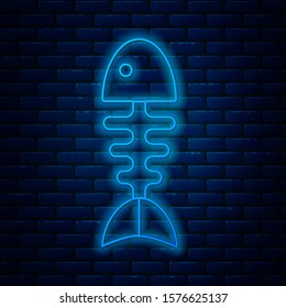Glowing neon line Fish skeleton icon isolated on brick wall background. Fish bone sign.  Vector Illustration