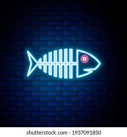 Glowing neon line Fish skeleton icon isolated on brick wall background. Fish bone sign. Colorful outline concept. Vector
