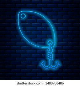 Glowing neon line Fishing spoon icon isolated on brick wall background. Fishing baits in shape of fish. Fishing tackle.  Vector Illustration