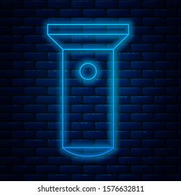 Glowing neon line Flashlight icon isolated on brick wall background.  Vector Illustration