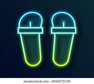 Glowing neon line Flip flops icon isolated on black background. Beach slippers sign.  Vector