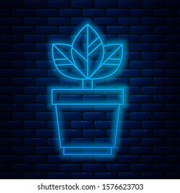 Glowing neon line Flowers in pot icon isolated on brick wall background. Plant growing in a pot. Potted plant sign.  Vector Illustration