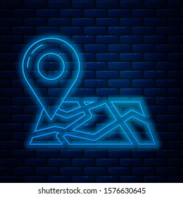 Glowing neon line Folded map with location marker icon isolated on brick wall background.  Vector Illustration