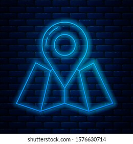 Glowing neon line Folded map with location marker icon isolated on brick wall background.  Vector Illustration