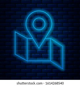 Glowing neon line Folded map with location marker icon isolated on brick wall background.  Vector Illustration