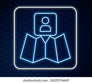 Glowing neon line Folded map with location marker icon isolated on brick wall background.  Vector