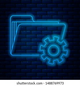 Glowing neon line Folder settings with gears icon isolated on brick wall background. Software update, transfer protocol, teamwork tool management.  Vector Illustration