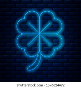 Glowing neon line Four leaf clover icon isolated on brick wall background. Happy Saint Patrick day.  Vector Illustration