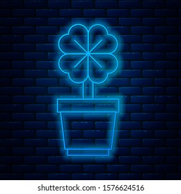 Glowing neon line Four leaf clover in pot icon isolated on brick wall background. Happy Saint Patrick day.  Vector Illustration