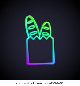 Glowing neon line French baguette bread icon isolated on black background.  Vector