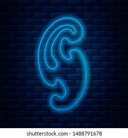 Glowing neon line French curves icon isolated on brick wall background. Sewing equipment.  Vector Illustration