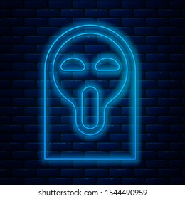 Glowing neon line Funny and scary ghost mask for Halloween icon isolated on brick wall background. Happy Halloween party.  Vector Illustration