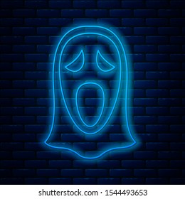 Glowing neon line Funny and scary ghost mask for Halloween icon isolated on brick wall background. Happy Halloween party.  Vector Illustration
