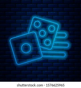 Glowing neon line Game dice icon isolated on brick wall background. Casino gambling.  Vector Illustration