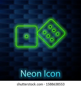 Glowing neon line Game dice icon isolated on brick wall background. Casino gambling.  Vector Illustration