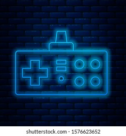 Glowing neon line Gamepad icon isolated on brick wall background. Game controller.  Vector Illustration