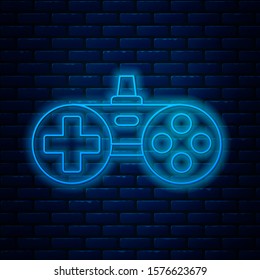 Glowing neon line Gamepad icon isolated on brick wall background. Game controller.  Vector Illustration