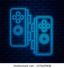 Glowing neon line Gamepad icon isolated on brick wall background. Game controller.  Vector Illustration