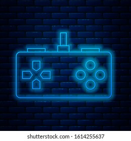 Glowing neon line Gamepad icon isolated on brick wall background. Game controller.  Vector Illustration